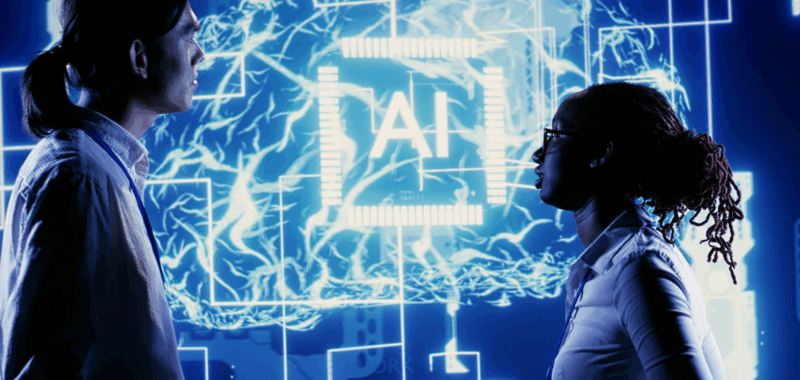 Dos profesionales analizando una interfaz digital con un sistema de Inteligencia Artificial, representando cómo la GenAI impulsa la innovación y automatización en fábricas de software modernas.